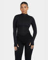 Person wearing a black bodysuit on a white background