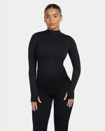 Person wearing a black bodysuit on a white background